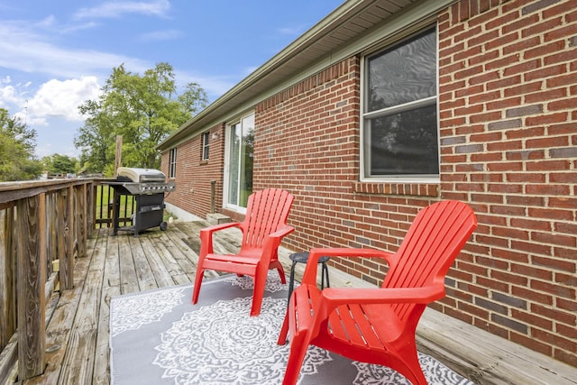 wooden deck featuring a grill