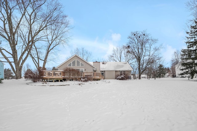 snow covered property with a deck