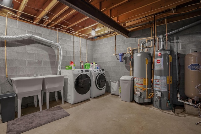 basement featuring water heater and washing machine and clothes dryer