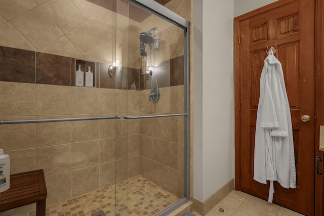 bathroom featuring an enclosed shower and tile patterned floors