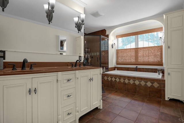 bathroom featuring vanity, tile patterned floors, crown molding, and shower with separate bathtub