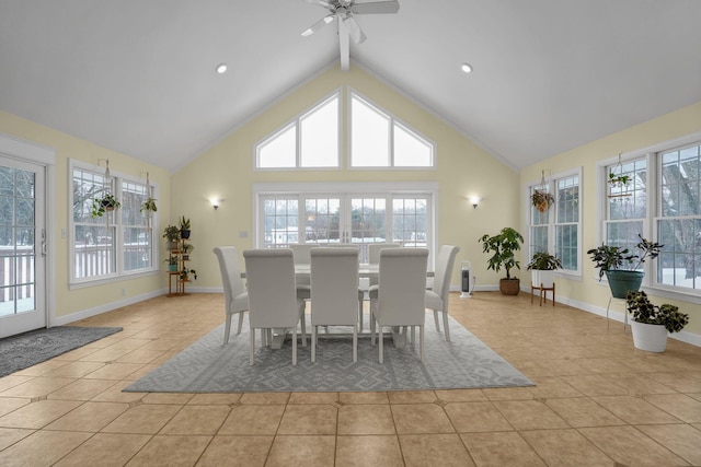 dining space with high vaulted ceiling, light tile patterned floors, ceiling fan, and a healthy amount of sunlight