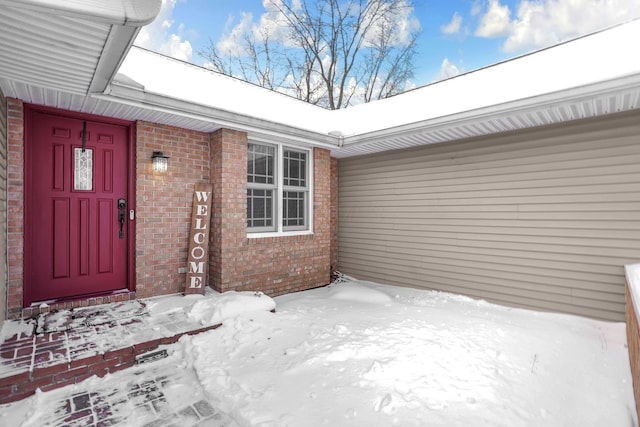 view of snow covered property entrance