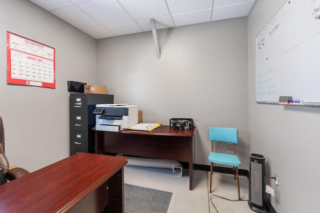 office featuring a paneled ceiling and concrete floors