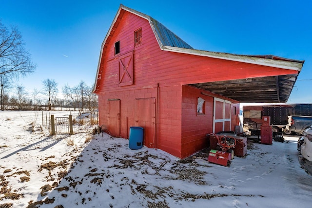 view of snowy exterior with an outbuilding