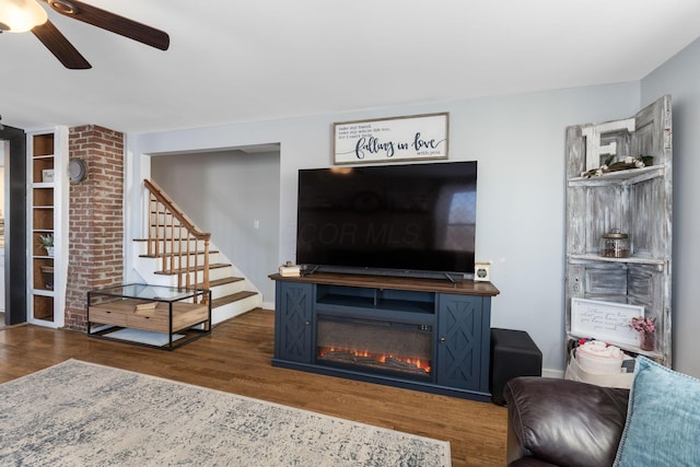 living room featuring ceiling fan and dark hardwood / wood-style flooring