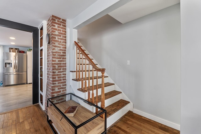 staircase featuring wood-type flooring