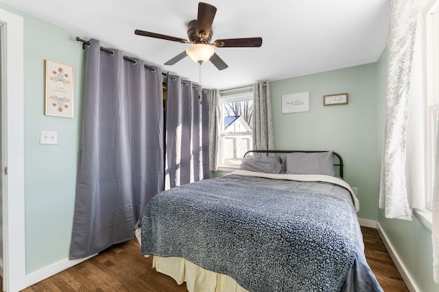 bedroom with ceiling fan and dark wood-type flooring