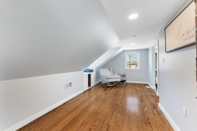 bonus room featuring vaulted ceiling and hardwood / wood-style flooring