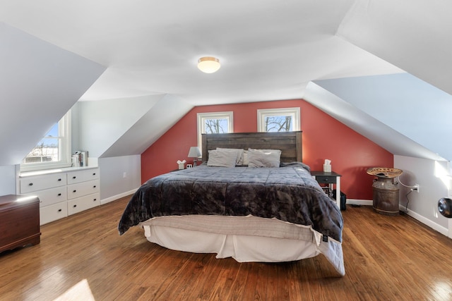 bedroom with vaulted ceiling and light wood-type flooring