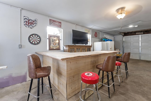 bar with white refrigerator with ice dispenser