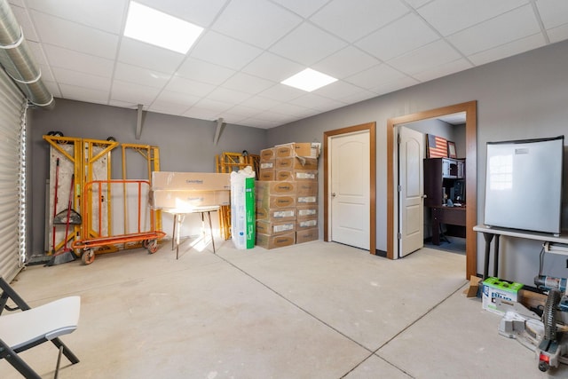 basement with a paneled ceiling