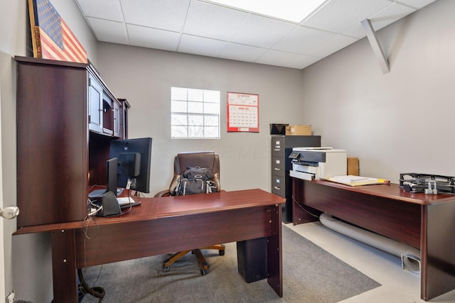 office space with a paneled ceiling