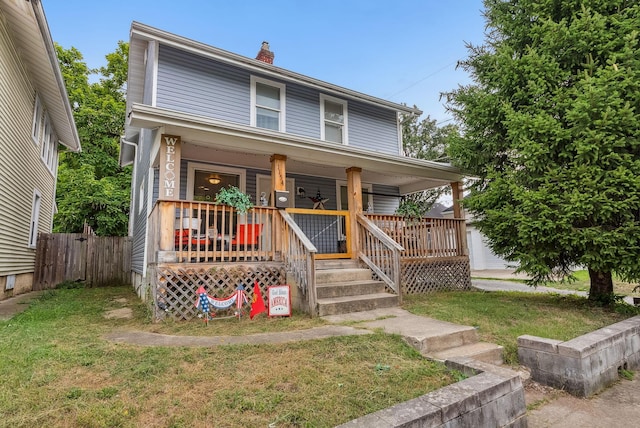 view of front of home featuring covered porch and a front yard