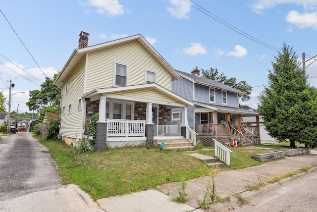 view of front of property with a front yard and a porch