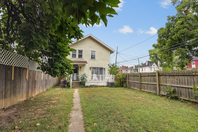 back of property featuring a lawn