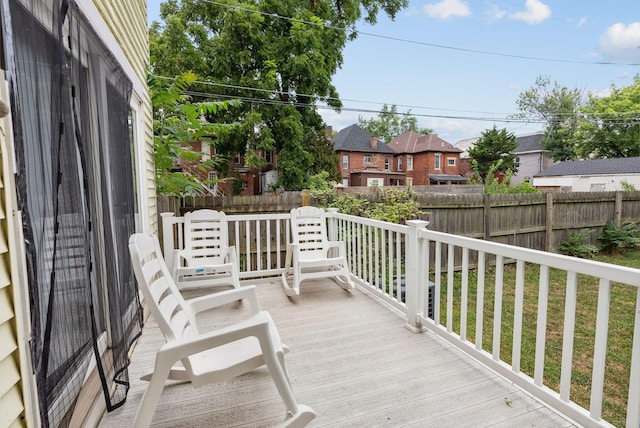 wooden terrace with a yard