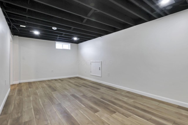 basement with hardwood / wood-style floors