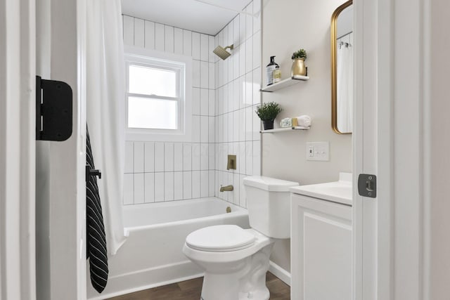 full bathroom with wood-type flooring, toilet, vanity, and tiled shower / bath combo