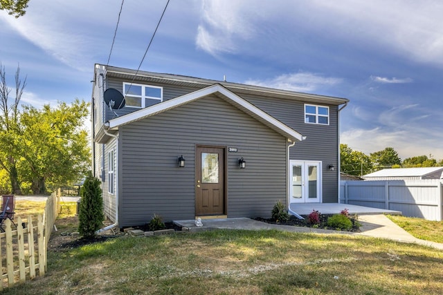 view of front of property featuring a front lawn and a patio