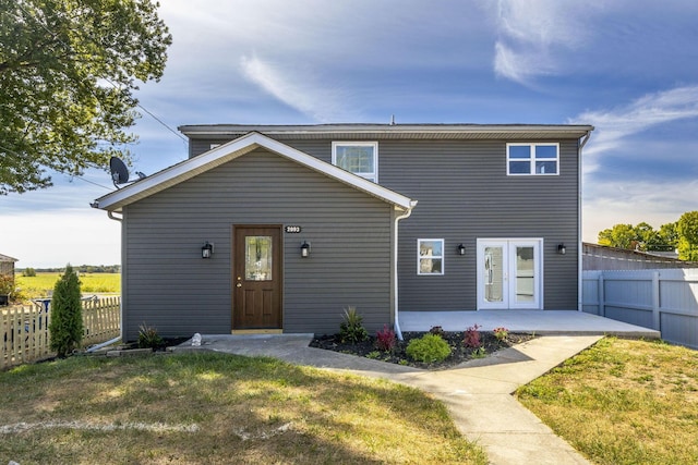 view of front of house featuring a front lawn and a patio