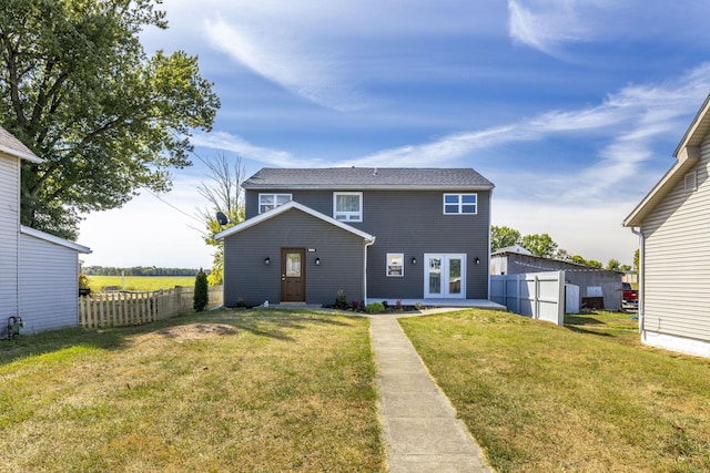 rear view of property featuring french doors and a lawn