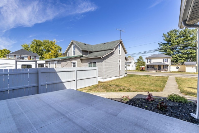 view of side of home with a lawn