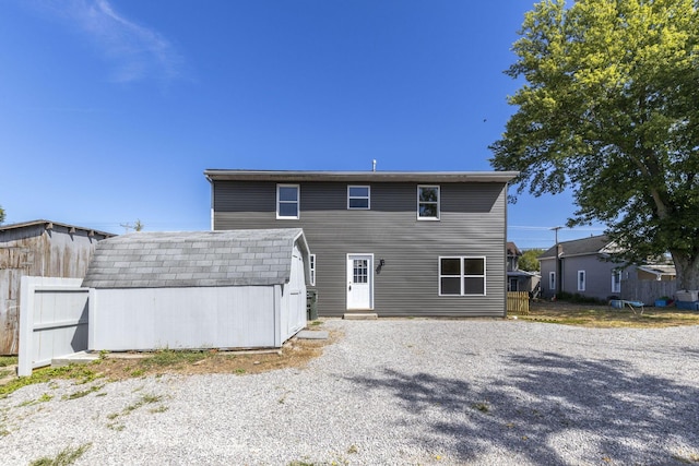 back of property featuring an outbuilding