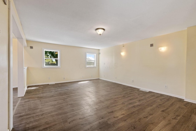 empty room featuring dark wood-type flooring