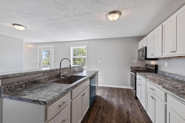 kitchen featuring white cabinetry, stainless steel appliances, dark hardwood / wood-style floors, tasteful backsplash, and sink