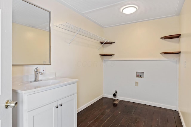 clothes washing area featuring washer hookup, dark hardwood / wood-style flooring, and sink