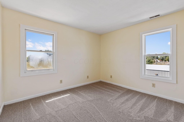 unfurnished room featuring carpet flooring