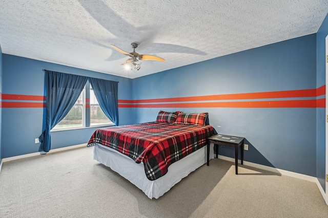 carpeted bedroom featuring a ceiling fan, a textured ceiling, and baseboards