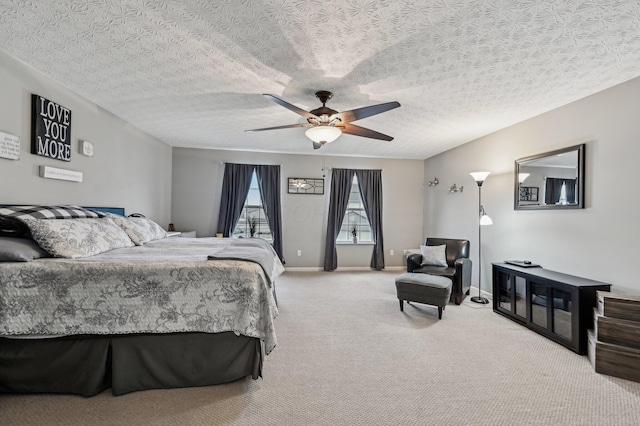 bedroom with carpet floors, ceiling fan, baseboards, and a textured ceiling