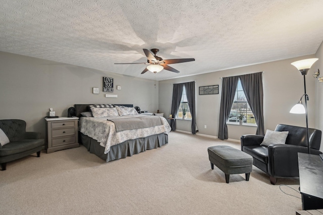 bedroom with a ceiling fan, light colored carpet, a textured ceiling, and baseboards