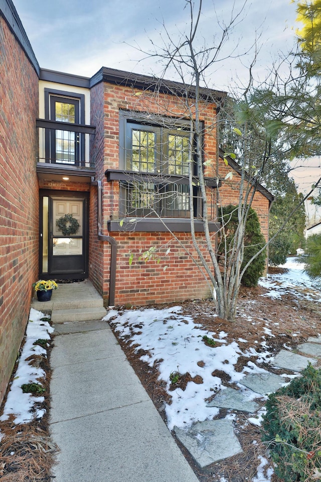 view of snow covered property entrance