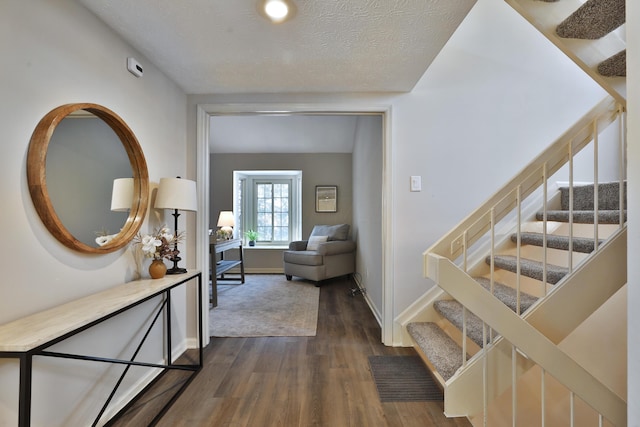 corridor featuring dark wood-type flooring and a textured ceiling