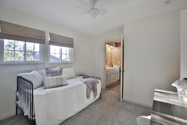 carpeted bedroom featuring connected bathroom and ceiling fan