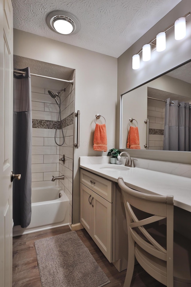 bathroom featuring vanity, wood-type flooring, a textured ceiling, and shower / bath combo with shower curtain