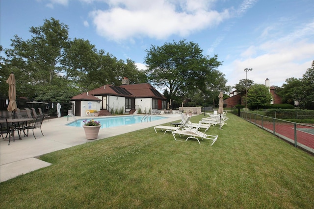 view of swimming pool featuring a lawn and a patio