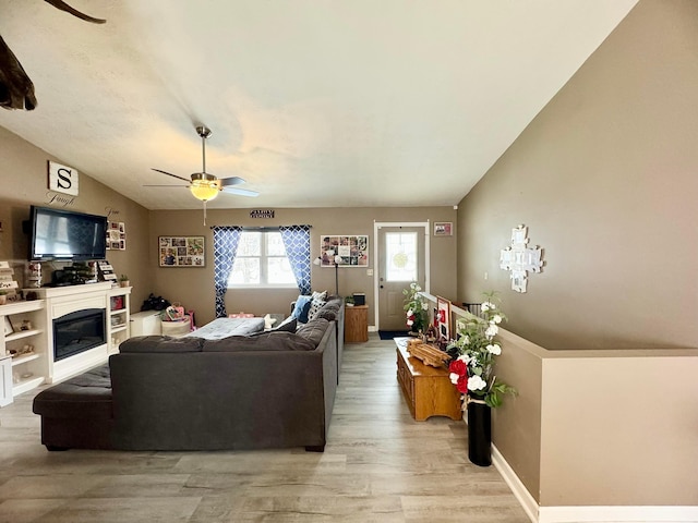 living room featuring ceiling fan and light hardwood / wood-style flooring