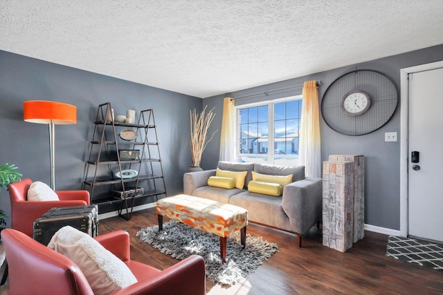 living room with dark hardwood / wood-style floors and a textured ceiling