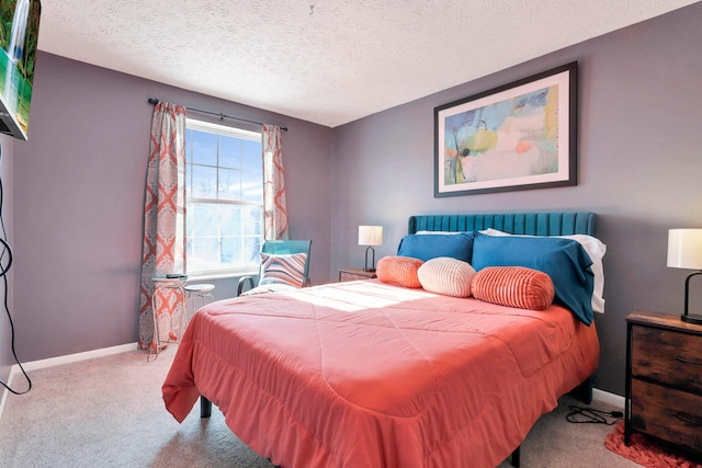 bedroom with light carpet and a textured ceiling