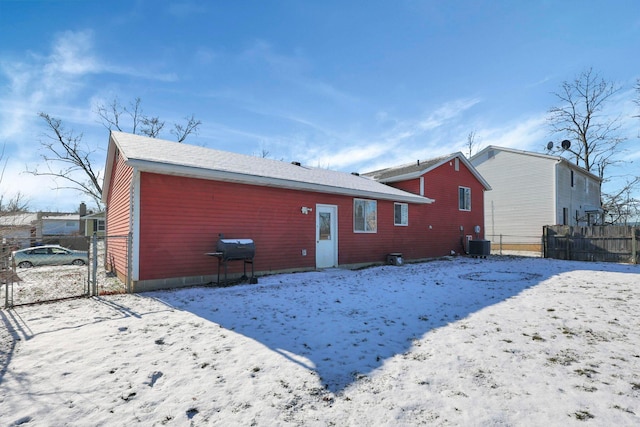 snow covered property with central AC