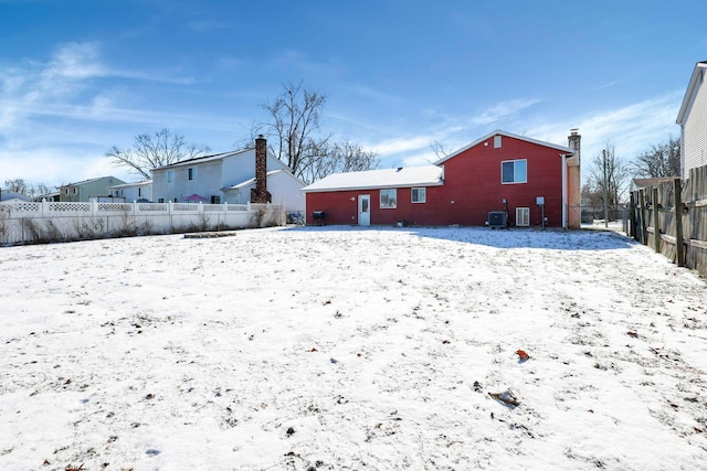 snow covered rear of property with cooling unit