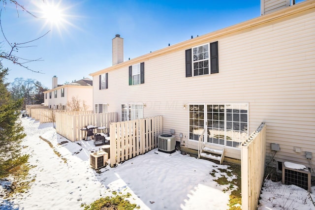 snow covered property featuring central air condition unit