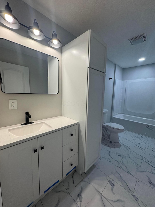 full bathroom featuring vanity, toilet, bathing tub / shower combination, and a textured ceiling