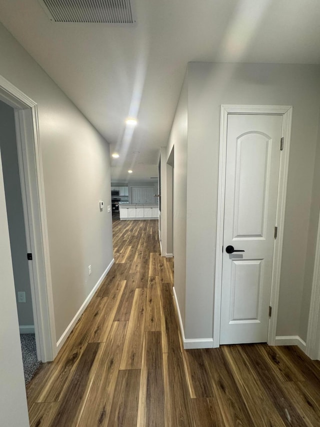 hallway featuring dark hardwood / wood-style flooring