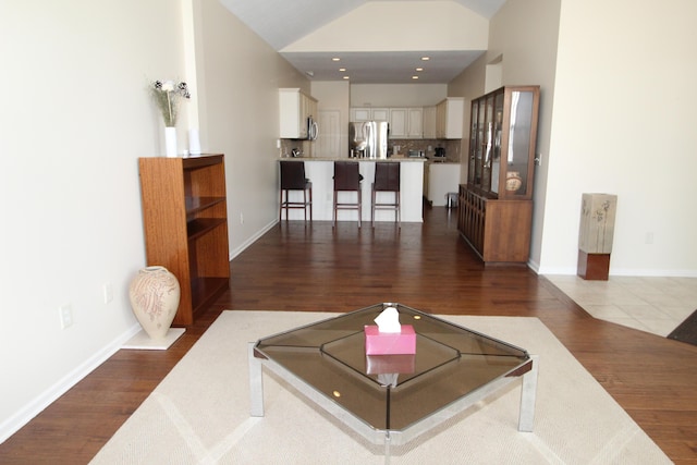 living room with hardwood / wood-style flooring and lofted ceiling