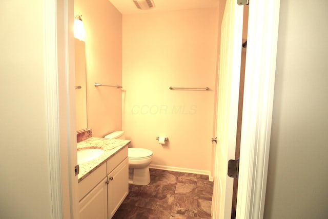 bathroom featuring vanity and toilet